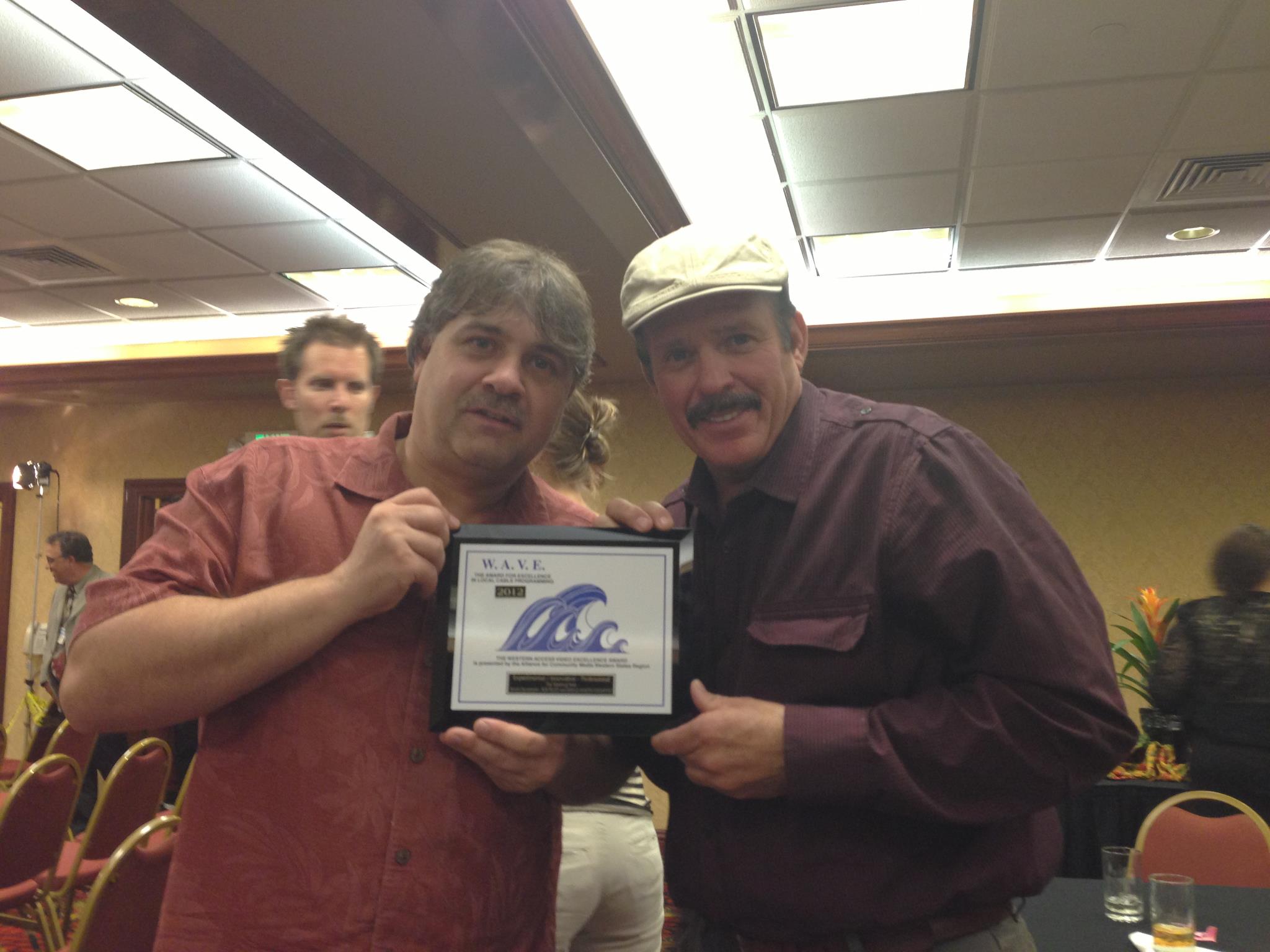 Gerald Martin Davenport and Rob Tillitz holding a WAVE Award for the WATERING hole.