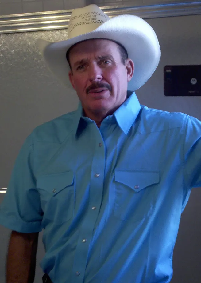the WATERING hole (2011) Rob Tillitz Wardrobe Light Blue Shirt with cowboy hat.