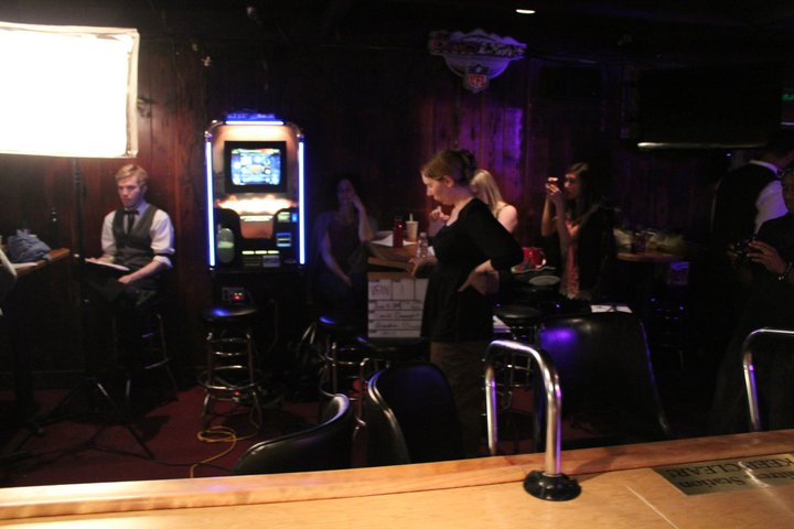 Krystina Mae: second assistant camera waits to slate the take - on the set of the WATERING hole Night 1 at the Cedar Room in Carmichael, California.