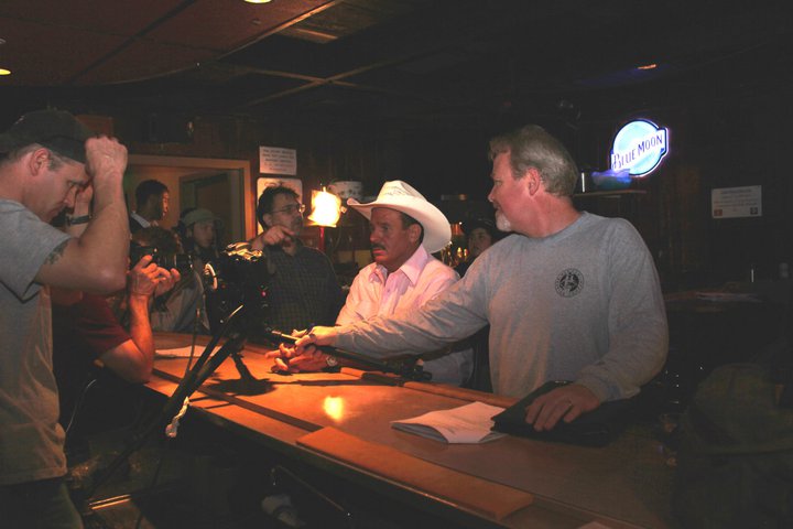 Brendan Brooks setting up Rob Tillitz for a take with Sean P. Flanagan: first assistant camera - on the set of the WATERING hole Night 1 at the Cedar Room in Carmichael, California.