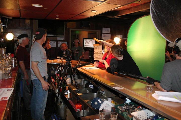 Mark Hoffman and Brendan Brooks. Krystina Mae with slate in front of Christa Bella - on the set of the WATERING hole Night 1 at the Cedar Room in Carmichael, California.