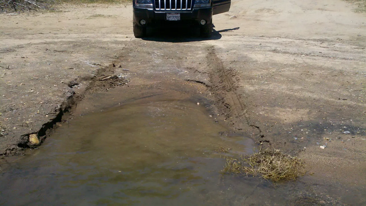 Donton's Point on Folsom Lake with tire tracks on shore.